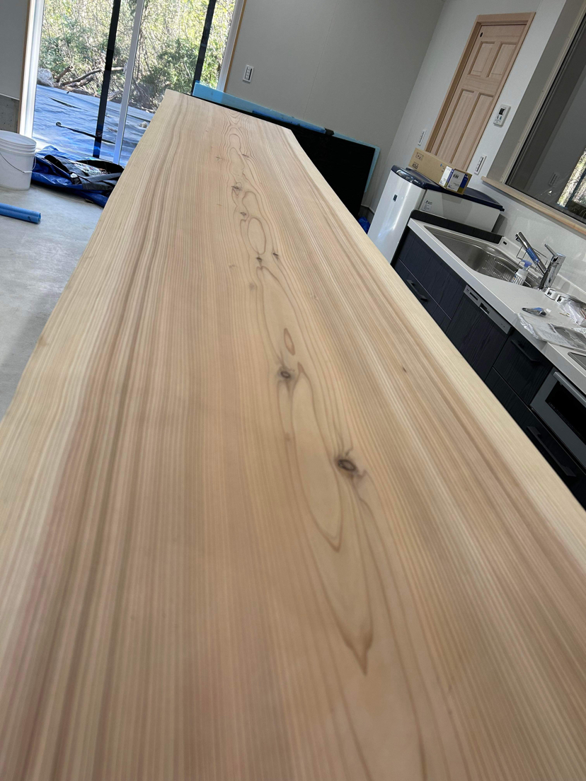 Close-up of the giant slab of Japanese live-edge cedar for the counter top in the Hakuba snowboard factory.